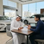 Customer discussing used car installment options at a professional UAE dealership.