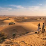 Travelers enjoying a desert experience among Dubai sand dunes