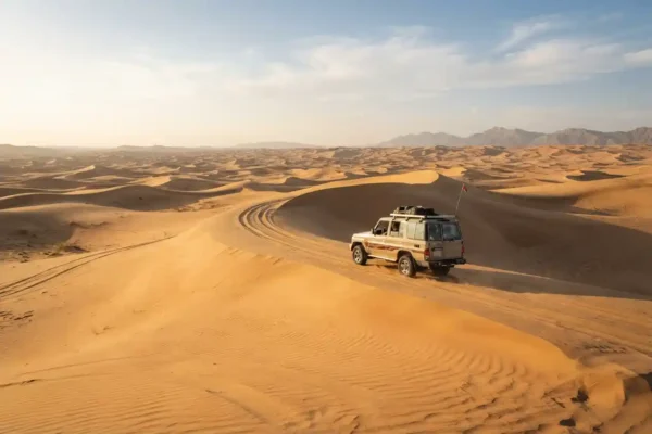 4x4 vehicle exploring golden dunes on a Dubai desert tour