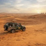 4x4 vehicle crossing golden dunes during a Dubai safari
