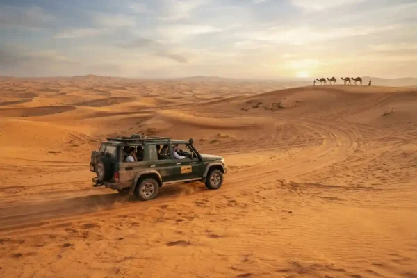 4x4 vehicle crossing golden dunes during a Dubai safari