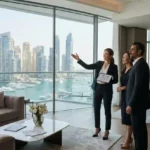 Professional real estate broker presenting a luxury apartment to clients in Dubai.